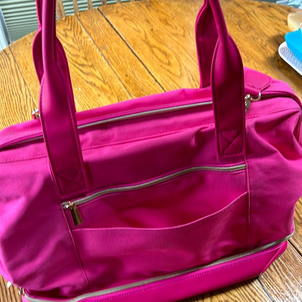 Members Mark large travel duffle bag with handles, shoulder strap, bright pink.
